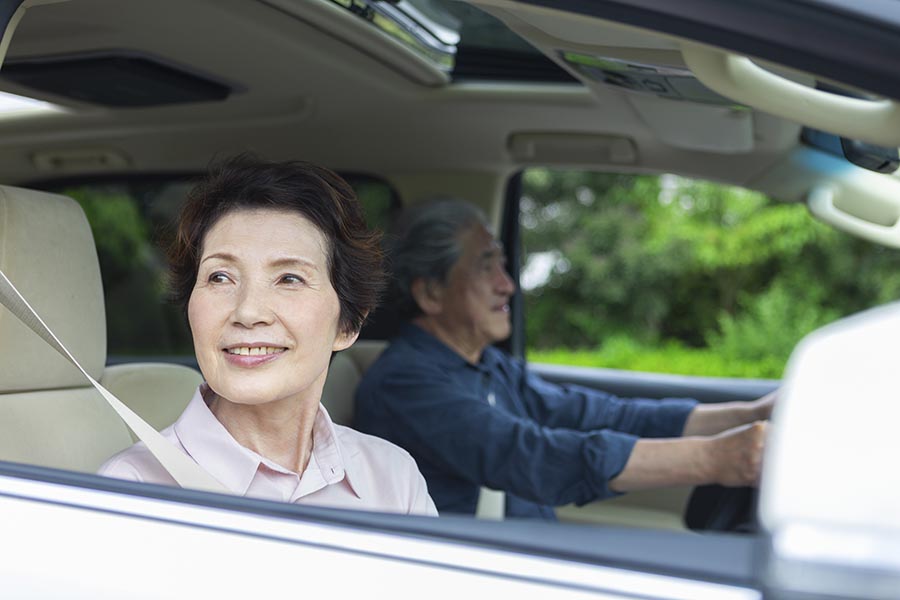 Client Center - Senior Couple Goes For a Drive, Wife Looking Out the Window Smiling